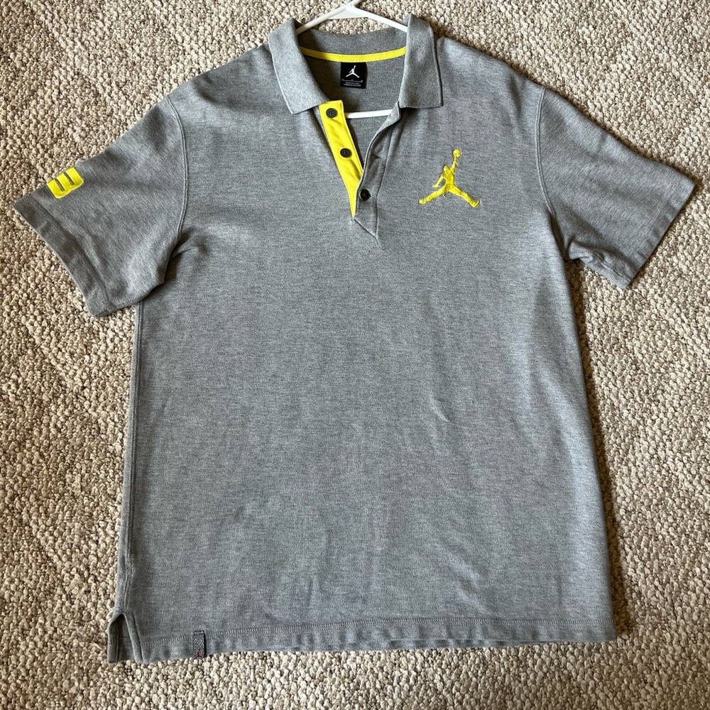 Jordan Mens Shirt- Grey Short Sleeve Polo W/ Yellow Jumpman Logo Embroidery.